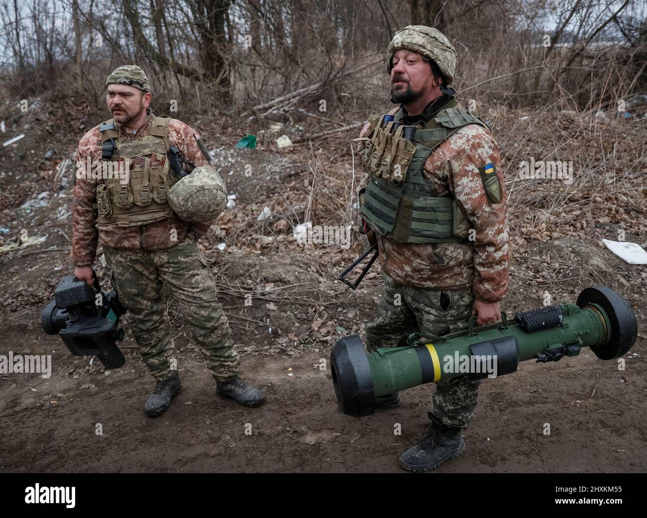 Ukrainian service members hold a Javelin missile system, at a position