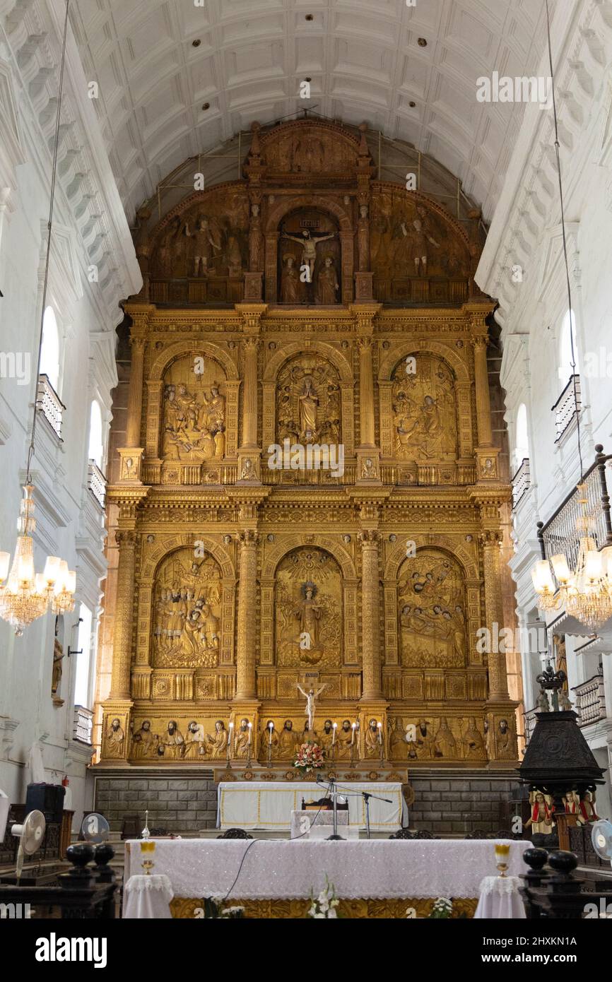 The main altar with its gilded reredos depicting scenes from the life of St. Catherine of Alexandria as well as her martyrdom at Se Cathedral, Old Goa Stock Photo