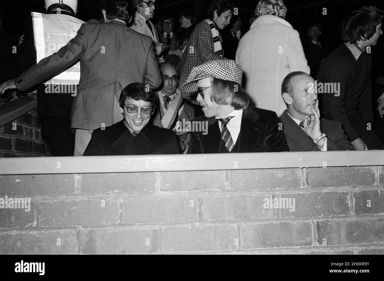 Graham Taylor and Elton John watching the football match, West Bromwich Albion v Watford.  25 October 1977. Stock Photo