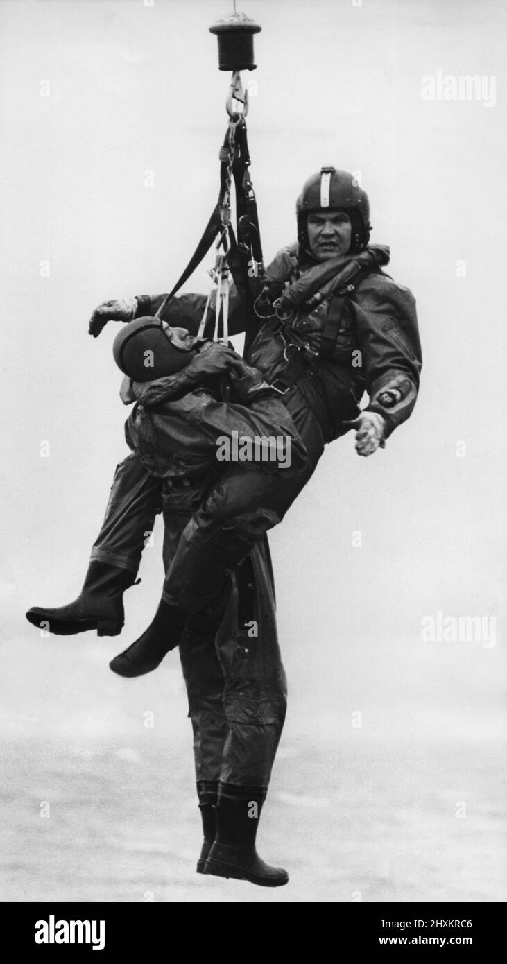 A RAF search and rescue Westland Whirlwind helicopter, from RAF Boulmer, takes part in a sea 'survival' rescue exercise. Winchman Flight Lientenant David Haslam-Eley brings up a 'survivor'.    15/03/1977 Stock Photo