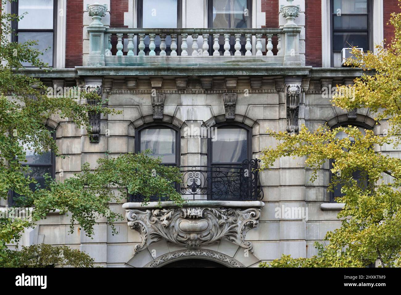 Elegant old New York apartment building surrounded by trees Stock Photo