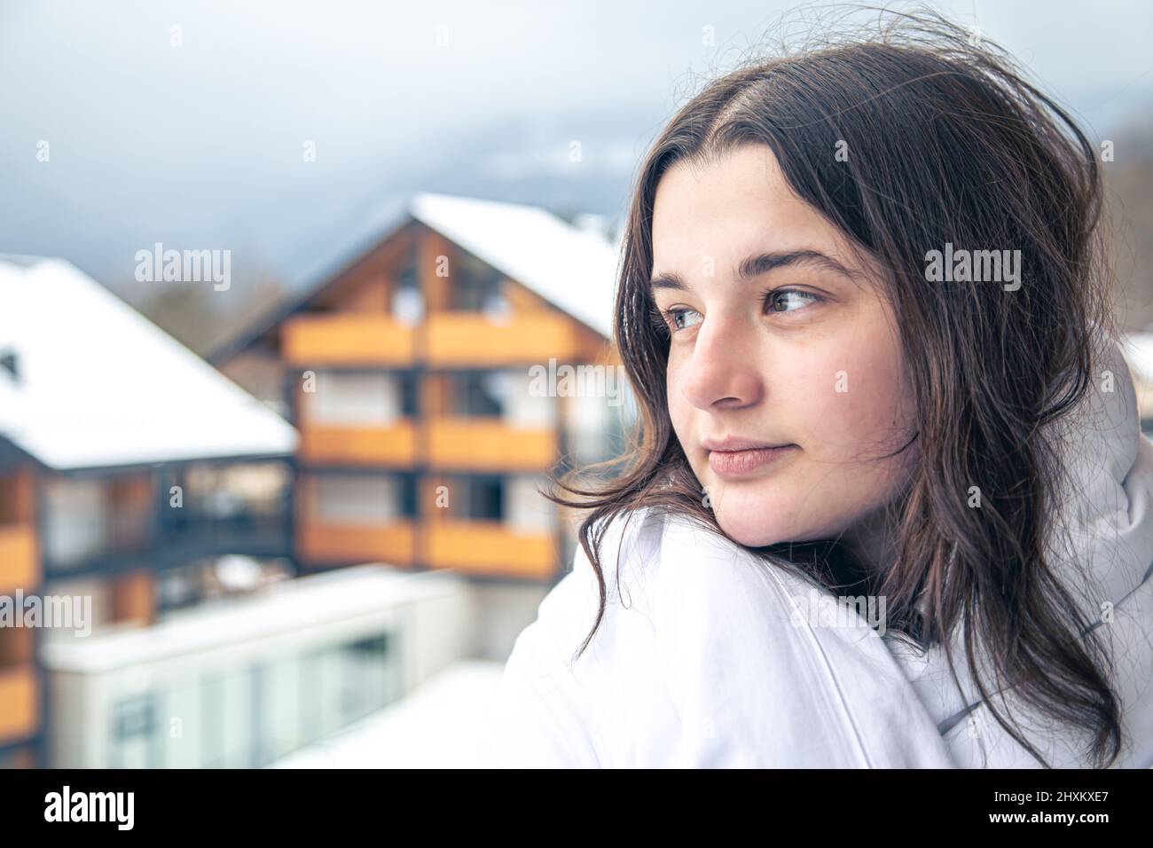 A young woman wrapped in a blanket on the balcony in the morning Stock ...