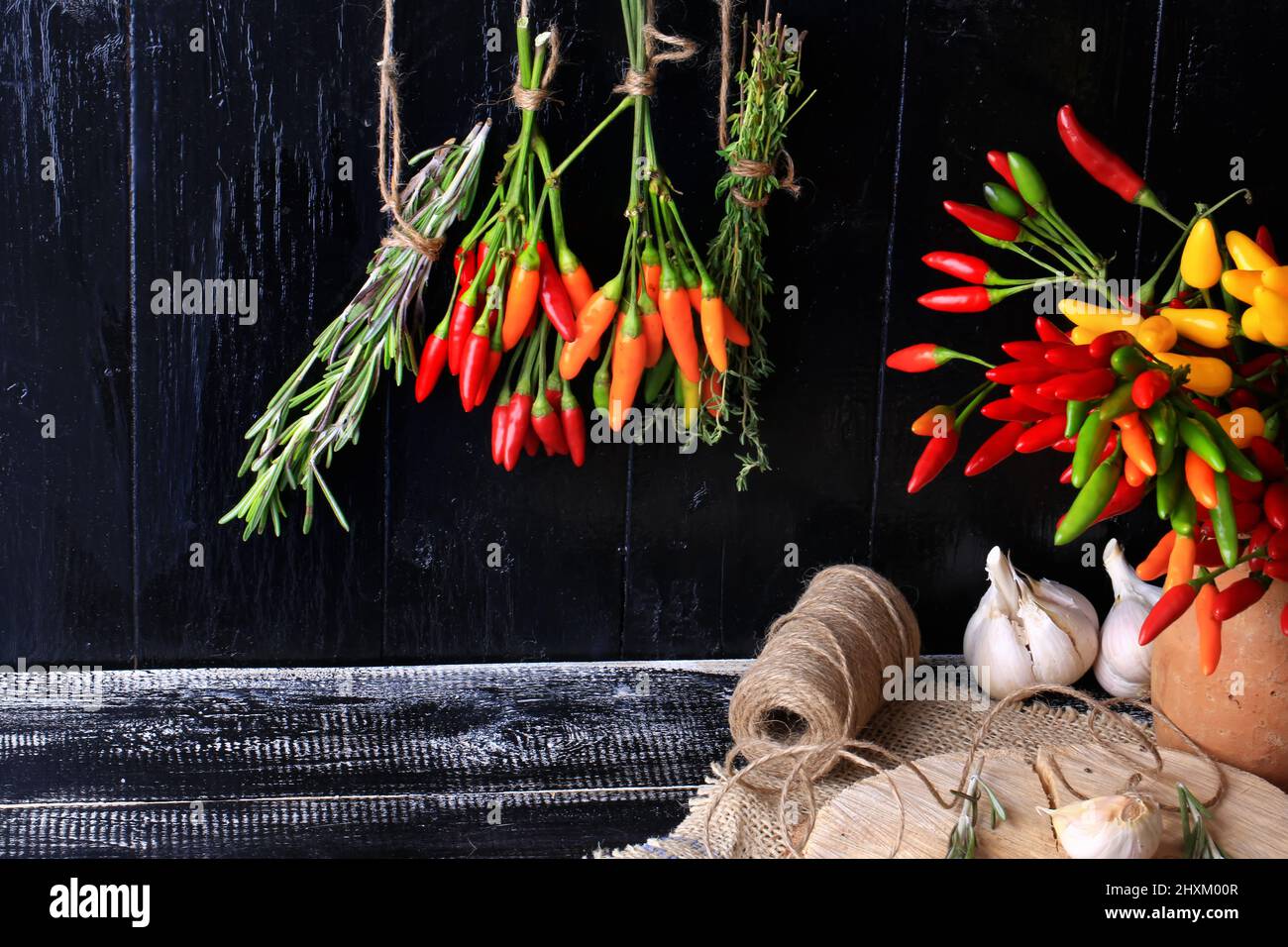 Spices and herbs bunch spice hot pepper rosemary thyme dark wood background retro style Cover for a cookbook; background Stock Photo