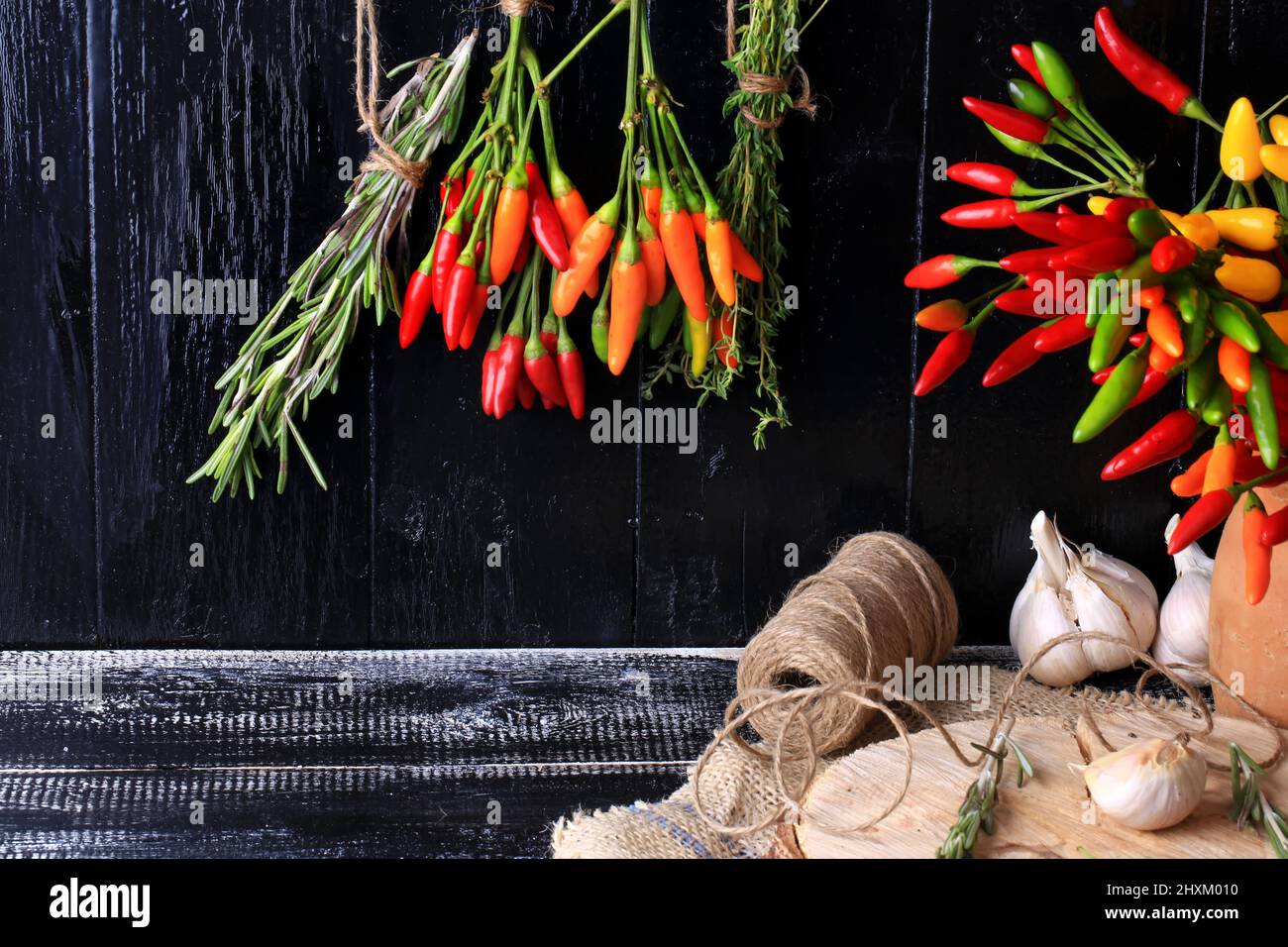 Spices and herbs bunch spice hot pepper rosemary thyme dark wood background retro style Cover for a cookbook; background Stock Photo