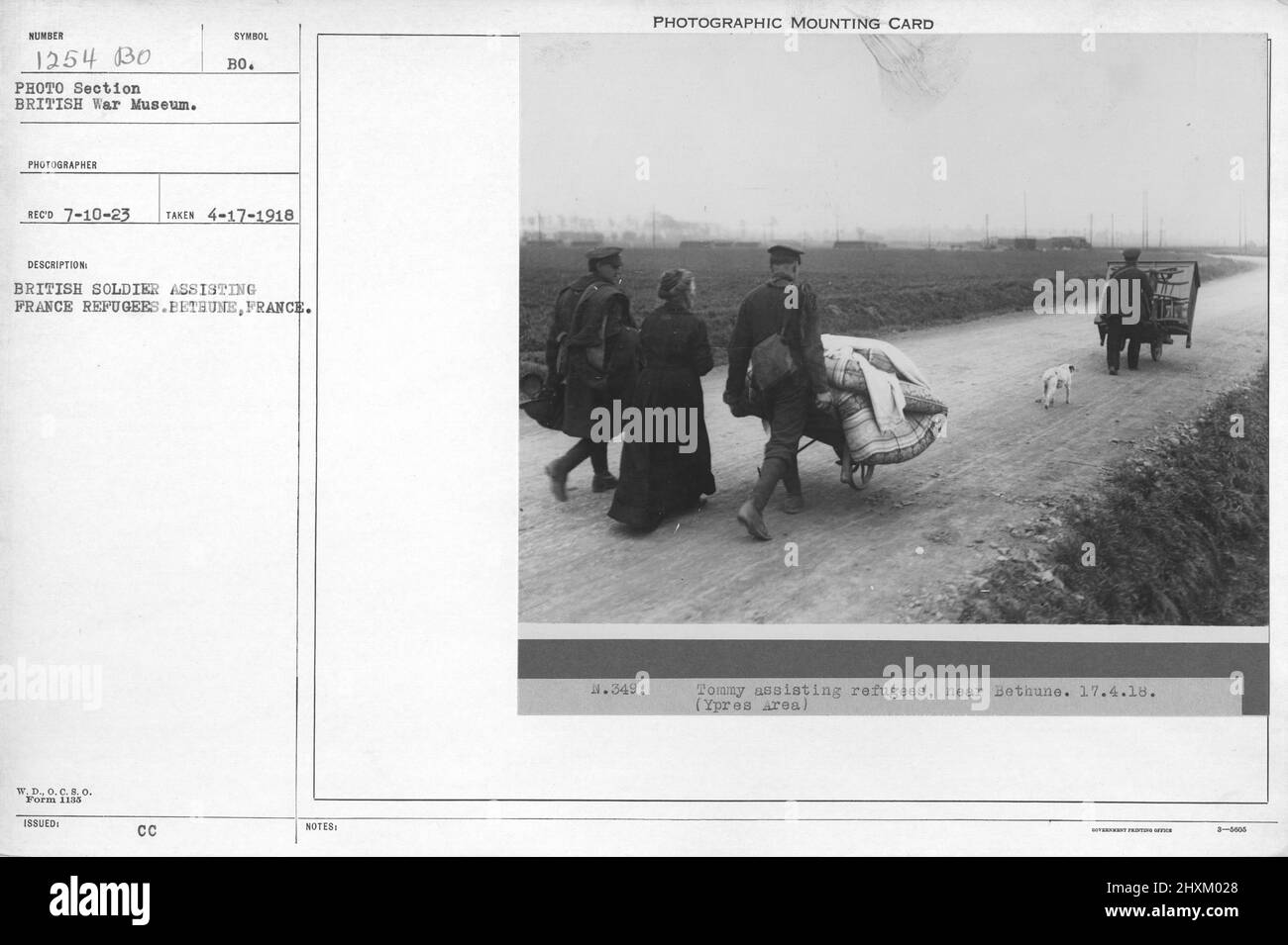 British soldier assisting France refugees. Bethune, France. 4-17-1918. Collection of World War I Photographs, 1914-1918 that depict the military activities of British and other nation's armed forces and personnel during World War I. Stock Photo