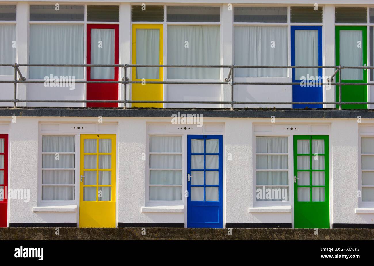 Primary coloured doors to beach chalets or huts overlooking Porthgwidden beach at St Ives, Cornwall, UK. Stock Photo