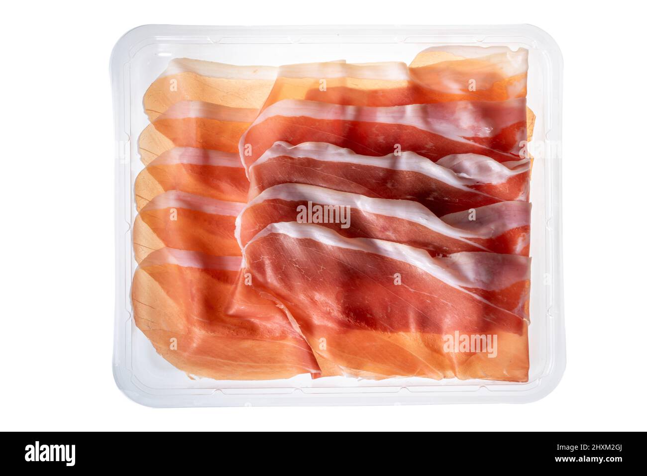 Sliced Parma ham in plastic tray for sale in supermarket, clipping path, top view Stock Photo