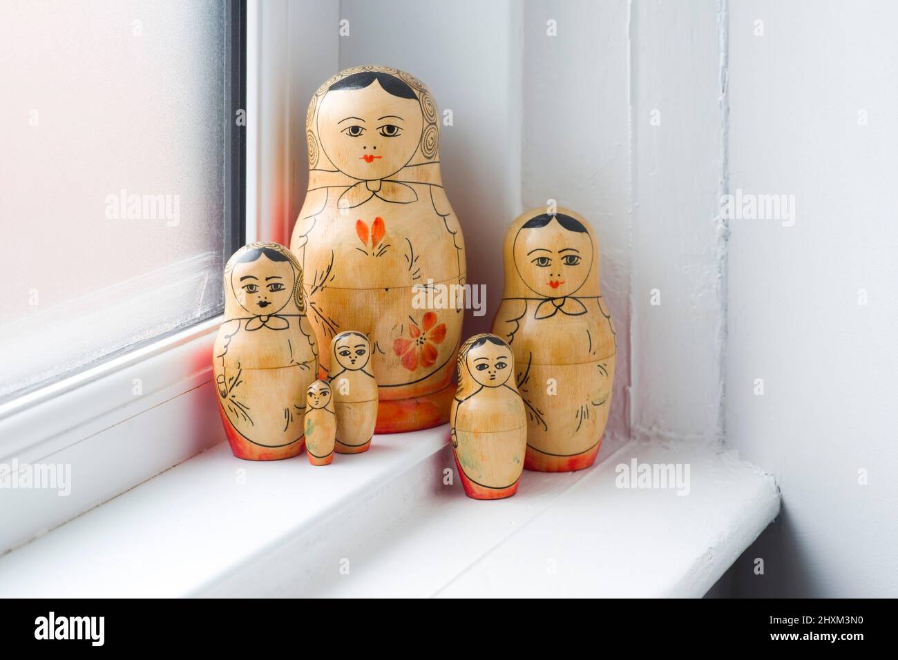 Family of Russian Dolls in a grouping on a window sill Stock Photo