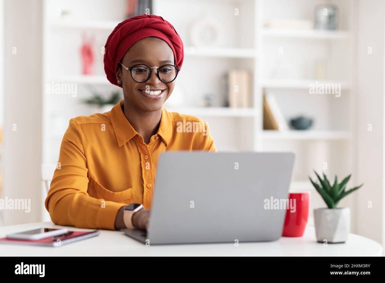 Cheerful millennial black woman entrepreneur working from home Stock ...