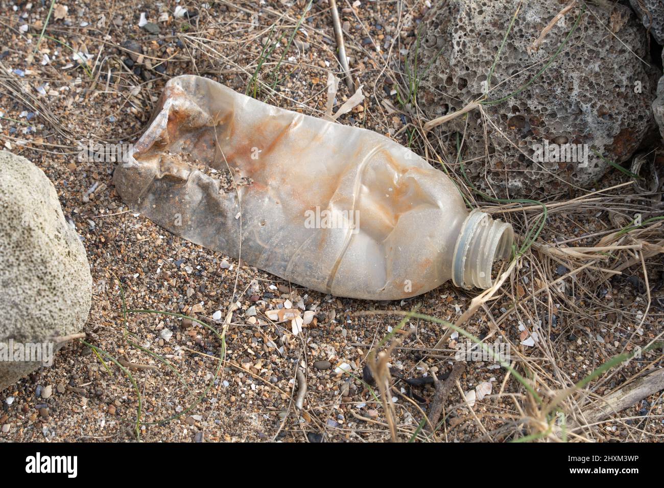 Pollution. Discarded plastic bottle, washed up on North Gare beach, near Hartlepool, Teesside, UK. Stock Photo