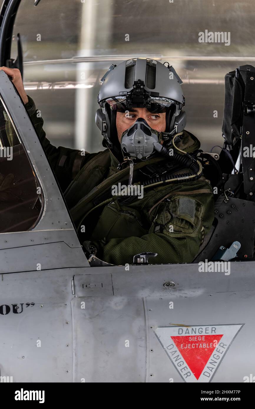 A French fighter glances out of the cockpit of his Rafale fighter jet at Mont-de-Marsan Air Base as he prepares to launch on a Combat Air Patrol (CAP) mission over Poland. On February 24, the French Air Force began flying sorties over Poland, contributing to the security of the skies over the eastern part of the Alliance. v Stock Photo