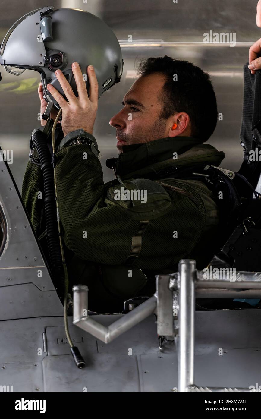 A French fighter pilot dons his helmet at Mont-de-Marsan Air Base as he prepares to launch on a Combat Air Patrol (CAP) mission over Poland. On February 24, the French Air Force began flying sorties over Poland, contributing to the security of the skies over the eastern part of the Alliance. (Photo: NATO) Stock Photo