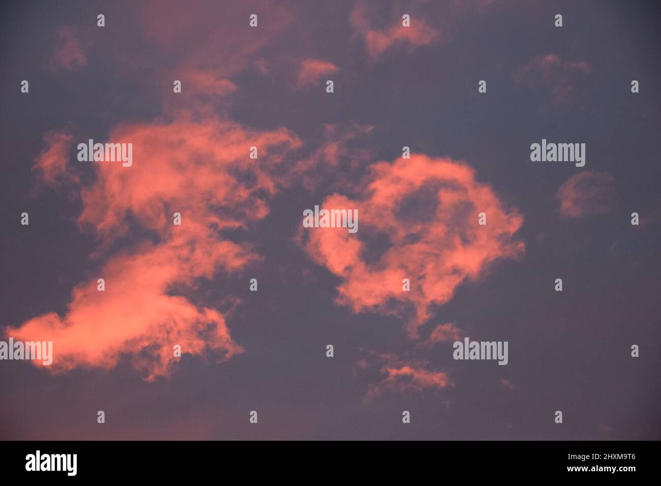 Shapes and patterns in the clouds set ablaze by the setting sun. Stock Photo