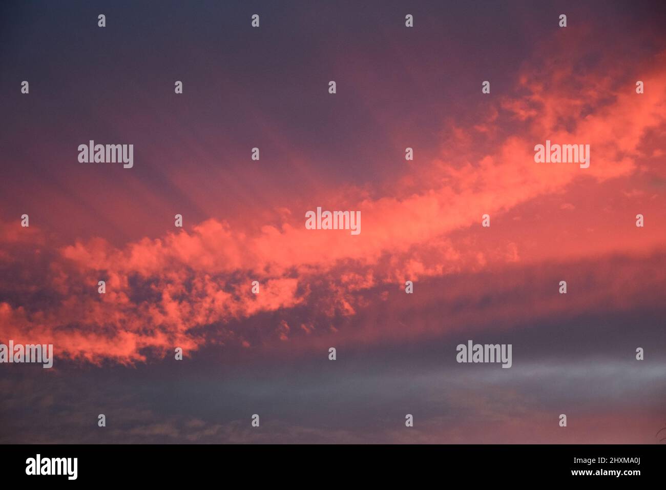 Shapes and patterns in the clouds set ablaze by the setting sun. Stock Photo