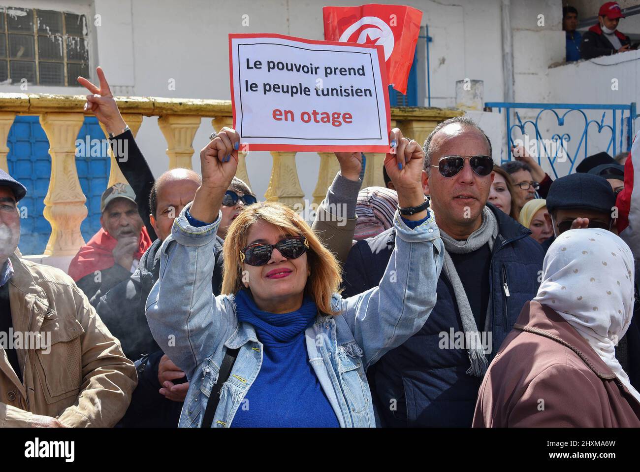 Tunis, Tunisia. 13th Mar, 2022. A protester holds a placard expressing her opinion during the demonstration. Protesters march along Khair El-Din Pasha Street, to demand an accurate and official calendar to end the exceptional period by dissolving Parliament and calling for early legislative elections with purification of the electoral climate to prevent fraud in the will of voters. Credit: SOPA Images Limited/Alamy Live News Stock Photo