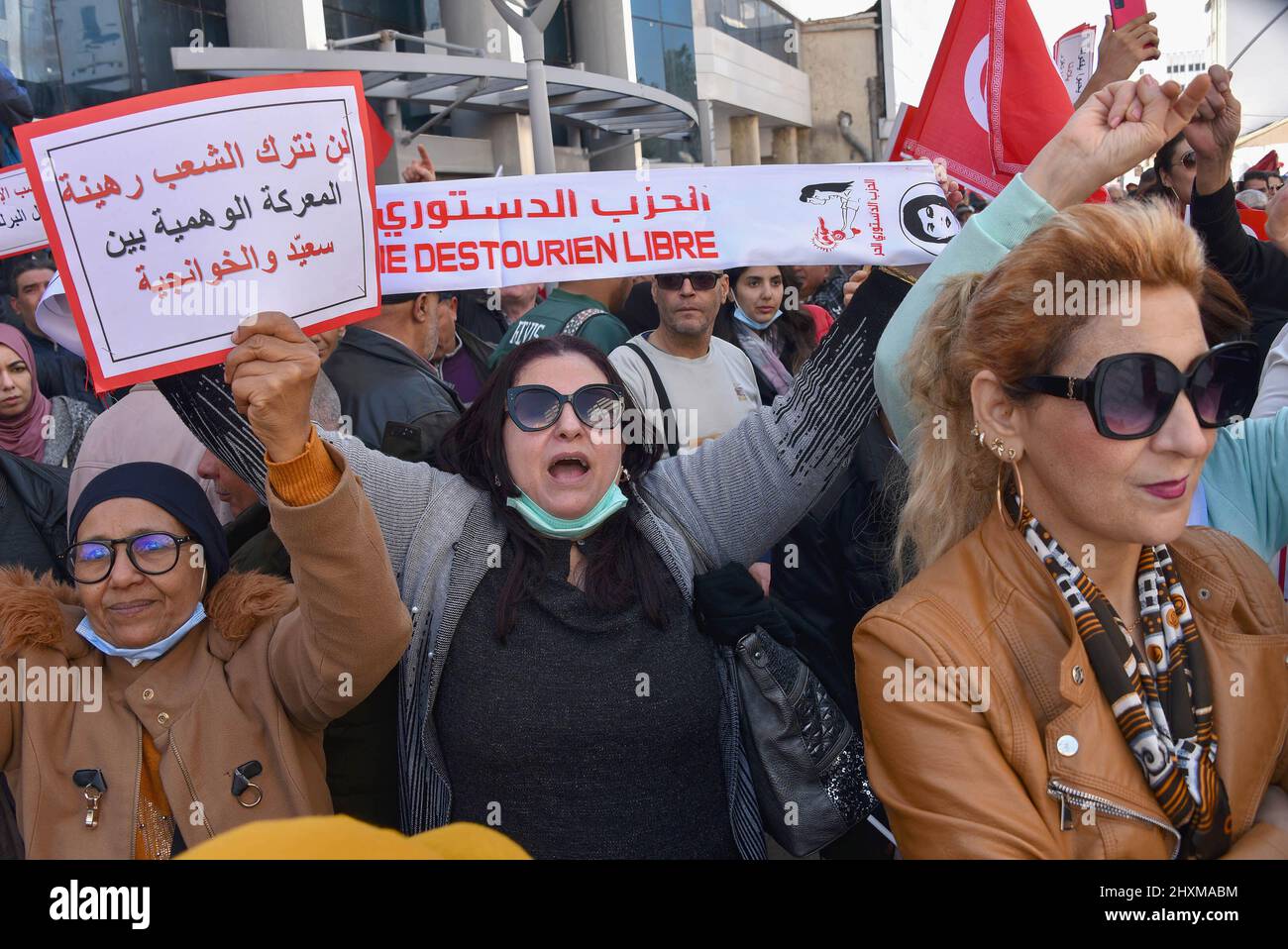 Tunis, Tunisia. 13th Mar, 2022. A protester holds a placard expressing her opinion during the demonstration. Protesters march along Khair El-Din Pasha Street, to demand an accurate and official calendar to end the exceptional period by dissolving Parliament and calling for early legislative elections with purification of the electoral climate to prevent fraud in the will of voters. (Photo by Jdidi Wassim/SOPA Images/Sipa USA) Credit: Sipa USA/Alamy Live News Stock Photo