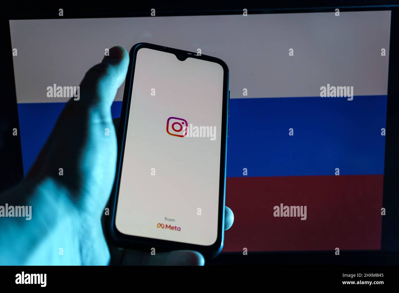 Instagram application on smartphone in Russian flag background. Russia ban instagram Stock Photo