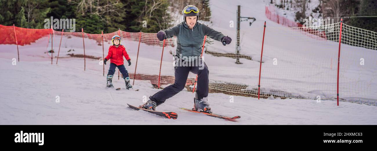 Boy learning to ski, training and listening to his ski instructor on the slope in winter BANNER, LONG FORMAT Stock Photo