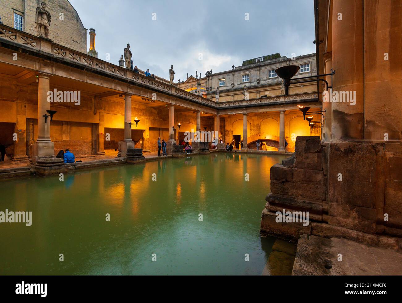 City of Bath, UK. 07-08-2021. Evening sightseeing of restored in Victorian times ancient Roman Baths in the light of wall sconces. Stock Photo