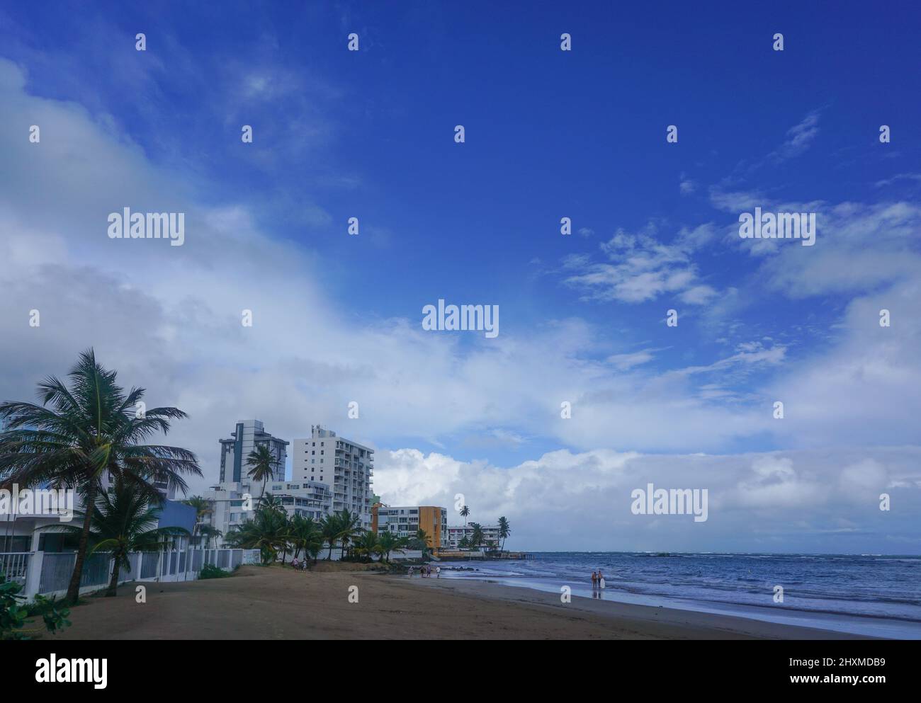 Isla Verde Beach, Puerto Rico, USA: Palm trees and hotels on a beach in Puerto Rico. Stock Photo