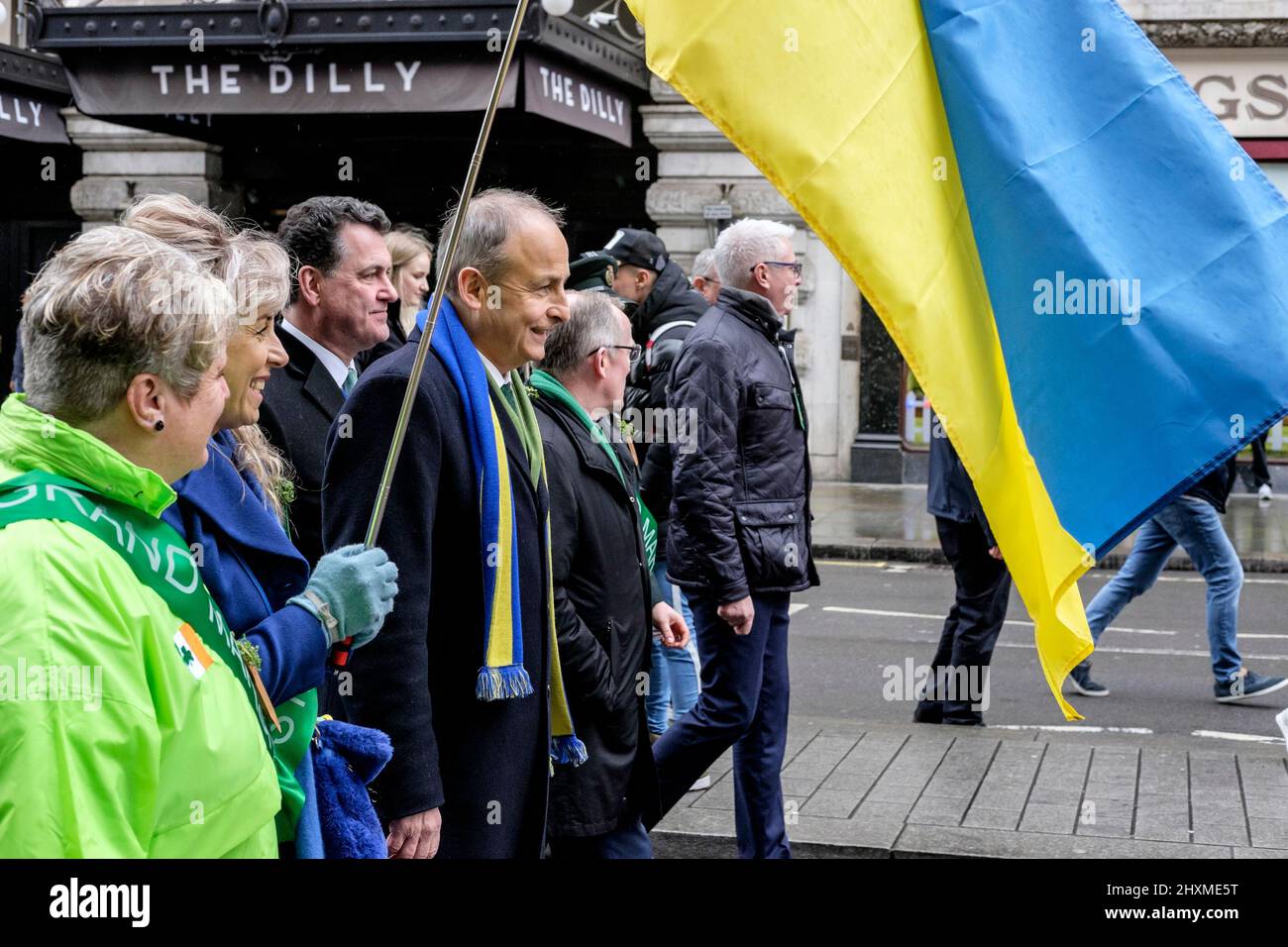 London, UK. 13th March 2022. The annual St Patrick's Day Parade returns to the capital after a two year hiatus due to the coronavirus pandemic. Irish premier Michael Martin joined in the event, wearing the colours of Ukraine and walking alongside its flag. The Taoiseach said he wanted show solidarity with the Ukrainian people. Stock Photo