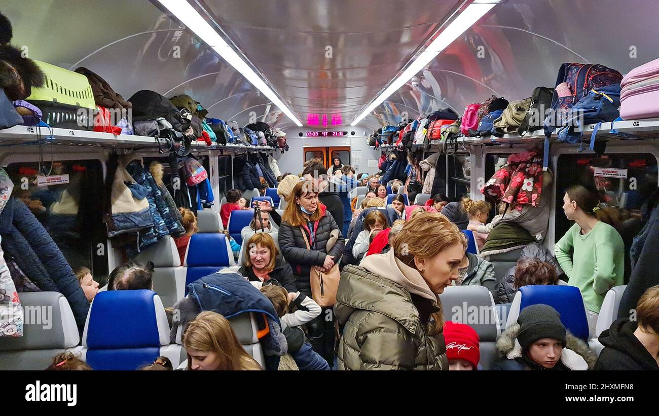 March 3, 2022 Ukraine, Lviv. Women and children are sitting in an evacuation train to go to Poland. Ukrainian refugees. War Stock Photo