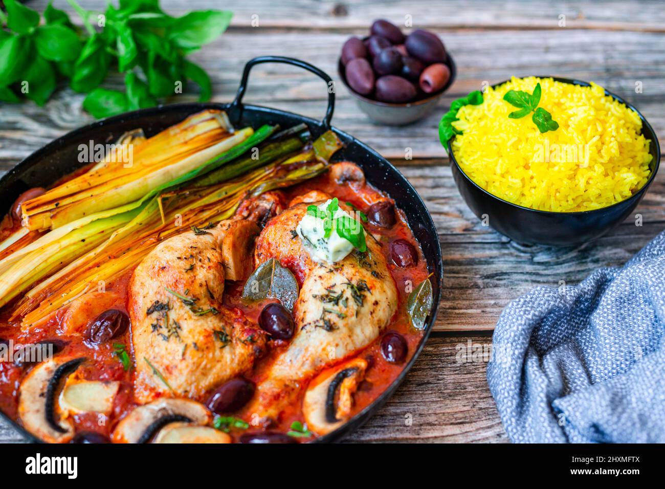 Oven roasted chicken legs with grilled leek, olives and mushroom in