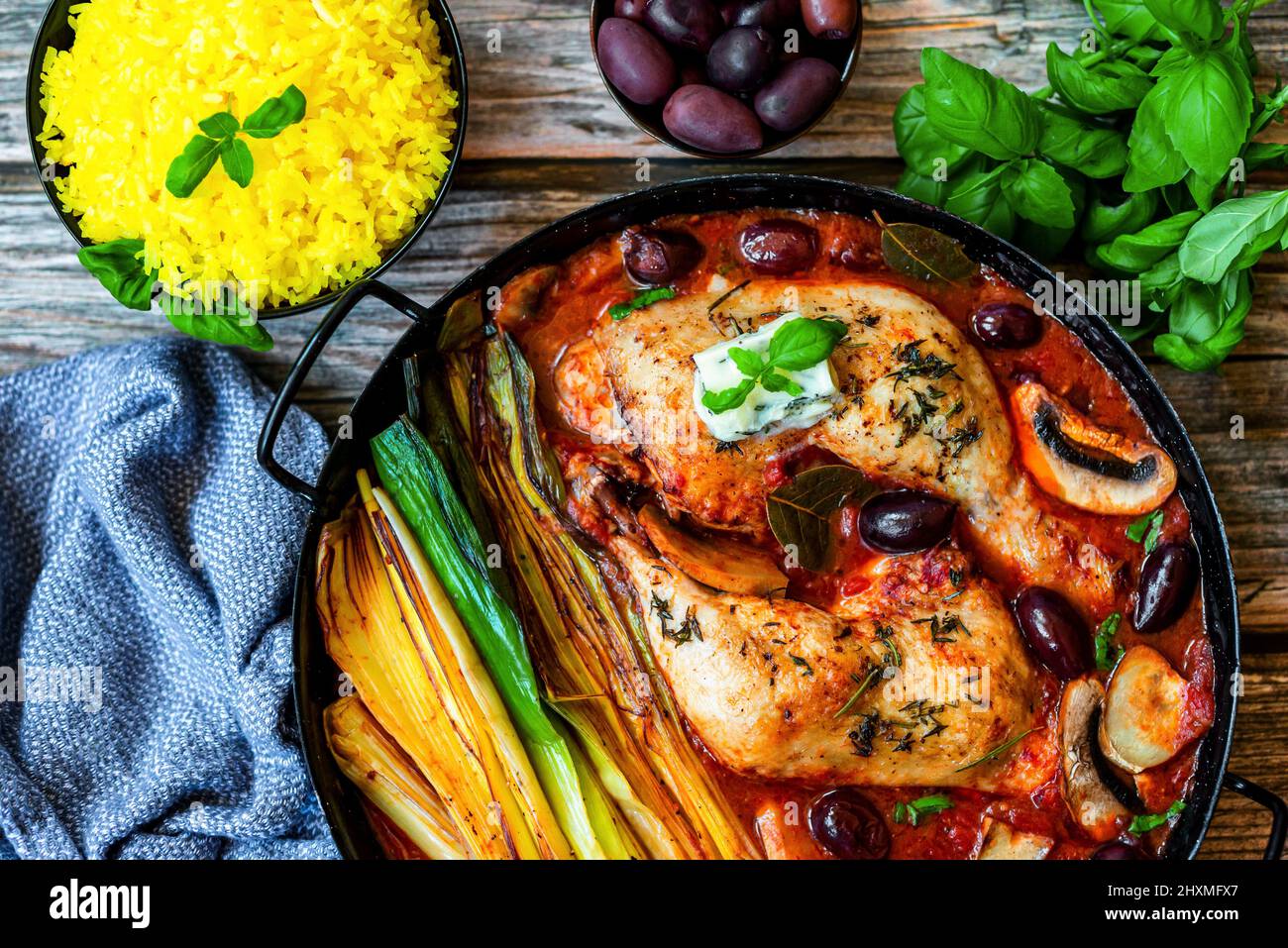 Oven roasted chicken legs with grilled leek, olives and mushroom in