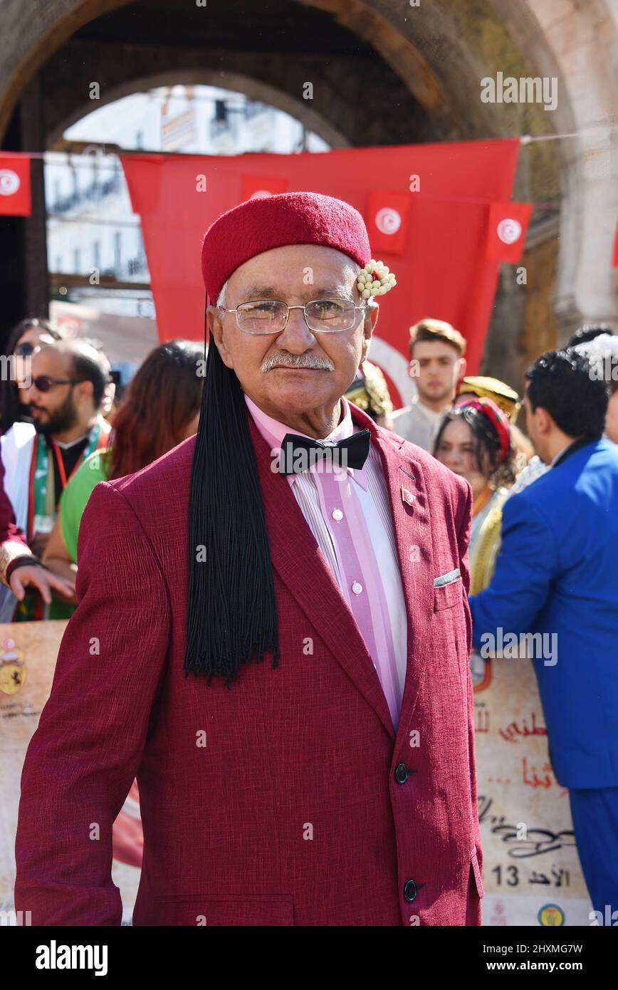Tunis, Tunisia. 13th Mar, 2022. A Tunisian elderly man, dressed traditional clothes takes part in a march during the National Day of Traditional Dress organized by Tunisia Heritage Association in Tunis, Every year in March, Tunisians commemorate their history by wearing their traditional dress to ensure that their past is not forgotten. This year participants began the march from Madrasa Slimania towards the Statue of Ibn Khaldun. Credit: SOPA Images Limited/Alamy Live News Stock Photo