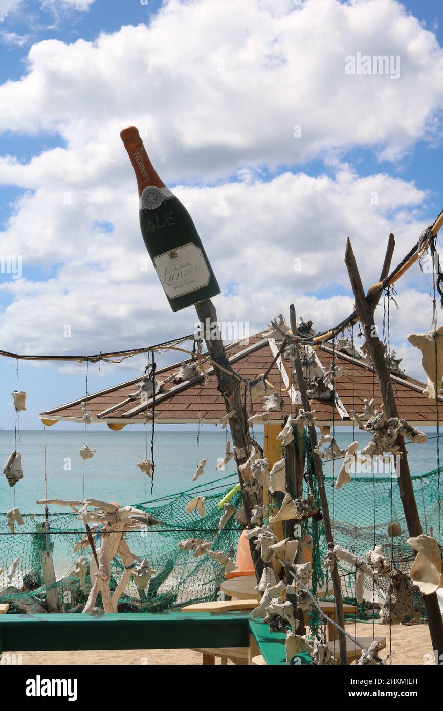 Lanson champagne bottle decorating a beach bar alongside seashells and