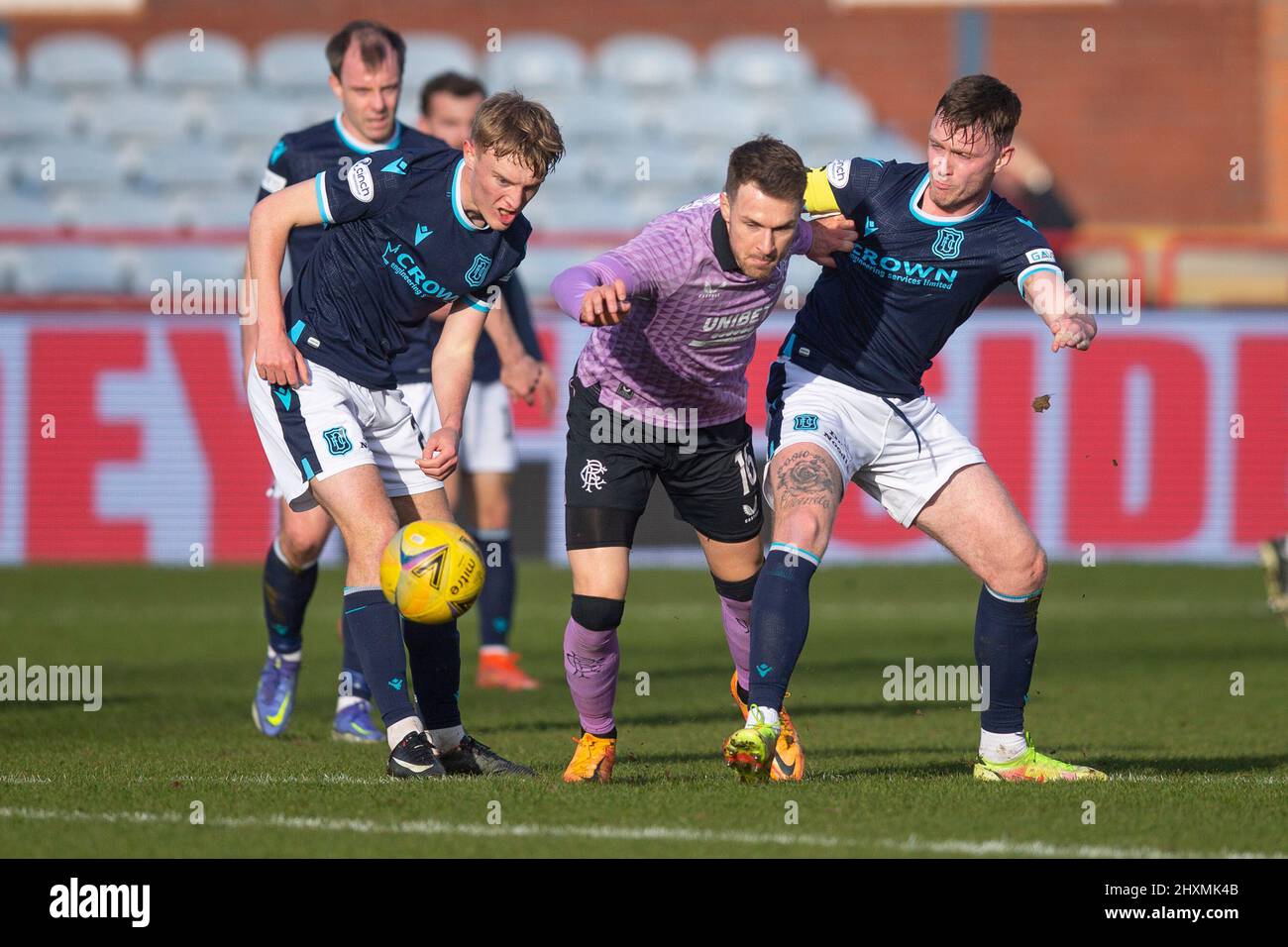 13th March 2022 ; Dens Park, Dundee, Scotland: Scottish Cup football, Dundee versus Rangers; Aaron Ramsey of Rangers challenges for the ball with Max Anderson and Jordan McGhee of Dundee Stock Photo
