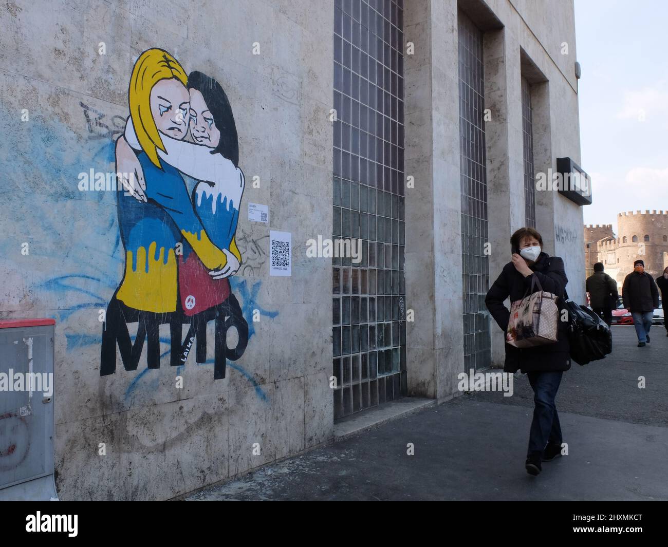 The street artist Laika dedicates her work of art to Ukrainian and Russian Women against the war with the word peace in cyrillic – Rome, Italy Stock Photo