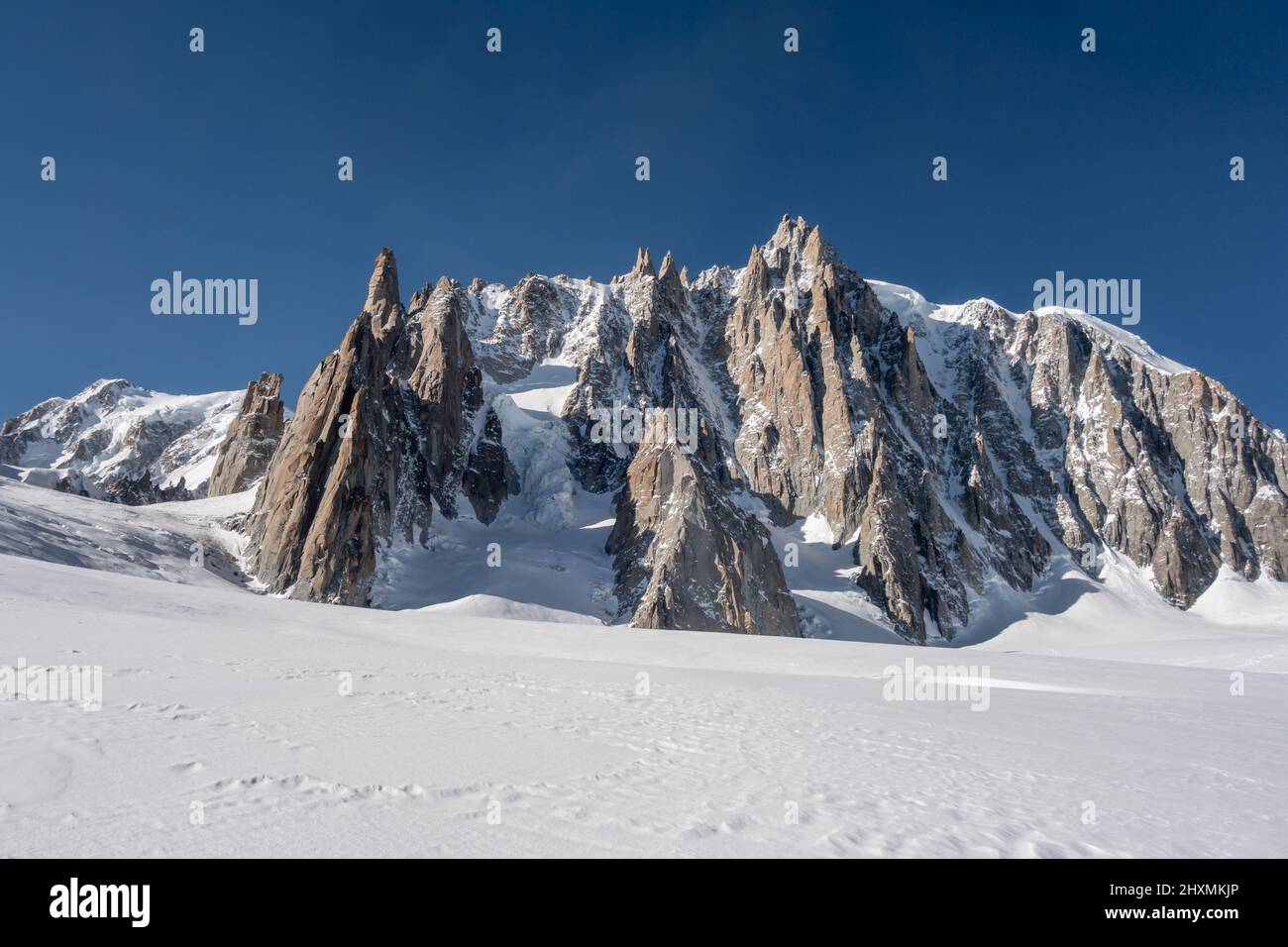 A cluster of different mountain peaks on the side of Mont Blanc du Tacul leading up towards the Mont Blanc and overlooking the Vallee Blanche off-pist Stock Photo
