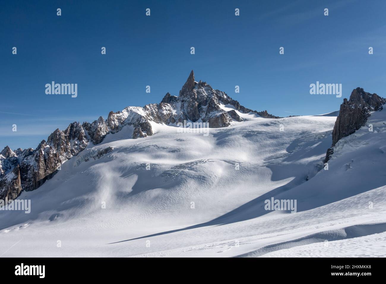 Dent du Geant rising above the mountain range separating Italy and France overlooking the Vallee Blanche off-piste itinerary in Chamonix France Stock Photo
