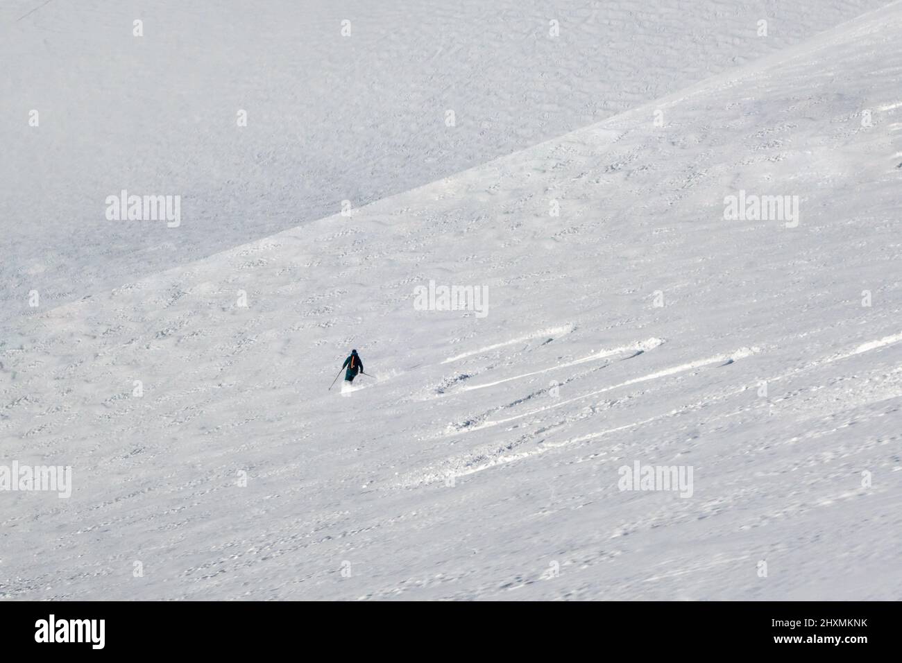 Chamonix, France - 12 February, 2022: Freeride skier in winter mountain slope in winter making first tracks in untouched snow in the Vallee Blanche Stock Photo
