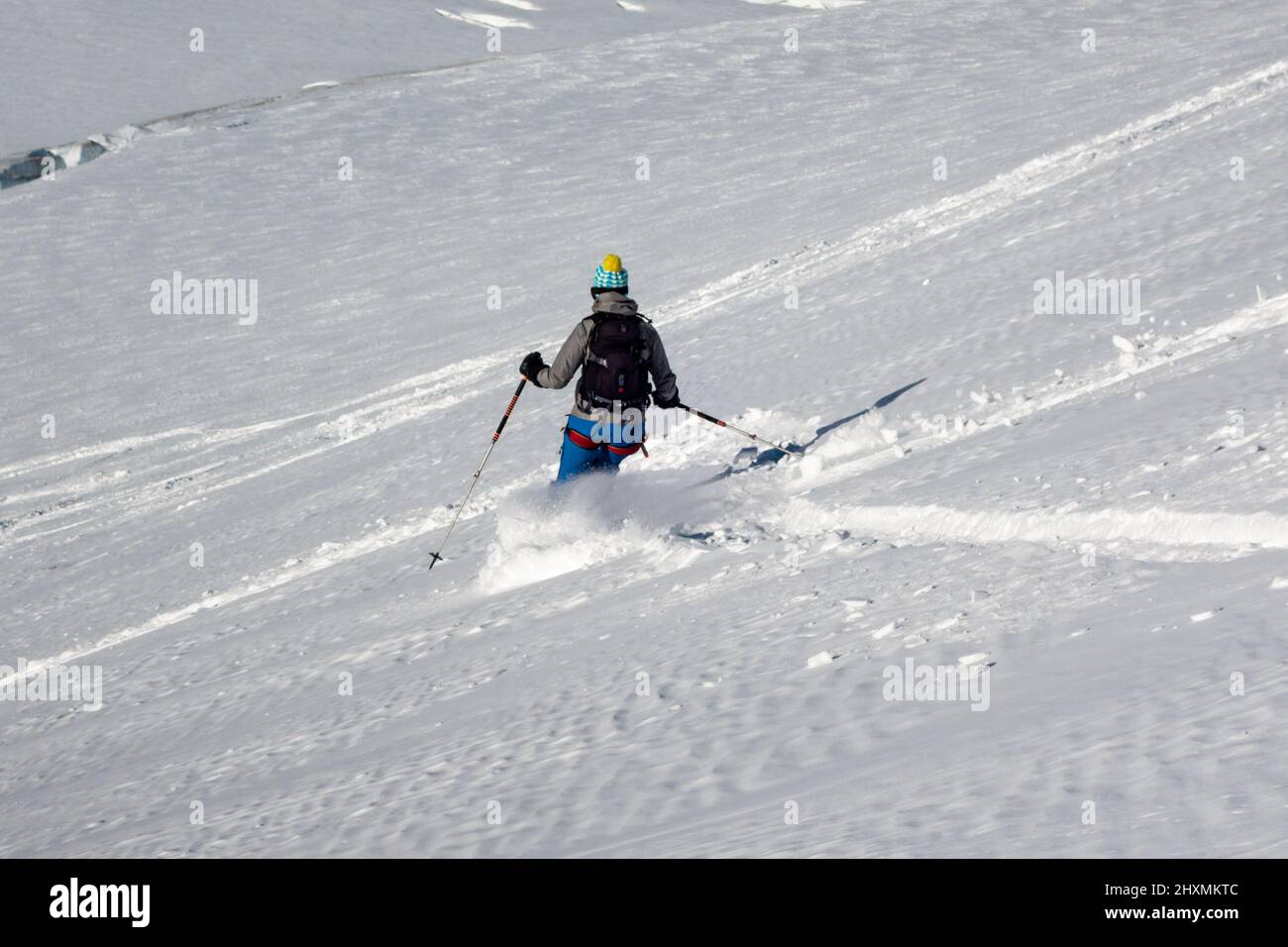 Single freeride female skier in snow covered mountain slope in winter making tracks in untouched virgin snow in the Vallee Blanche in Chamonix France Stock Photo