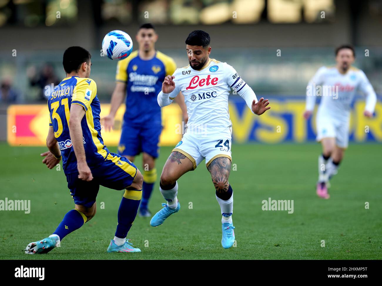 VERONA, ITALY - MARCH 13: Lorenzo Insigne of SSc Napoli competes for the ball with Bosko Sutalo of Hellas Verona ,during the Serie A match between Hellas and SSC Napoli at Stadio Marcantonio Bentegodi on March 13, 2022 in Verona, Italy. (Photo by MB Media) Stock Photo