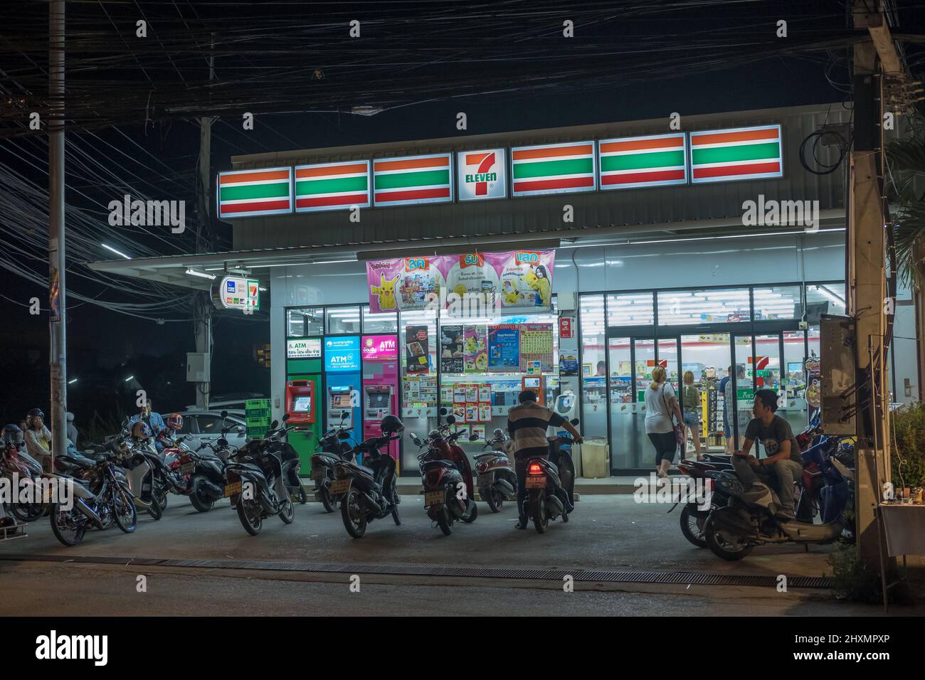 Urban scene at a Seven Eleven store at night south of Hua Hin. Hua Hin is a major travel destination. Stock Photo