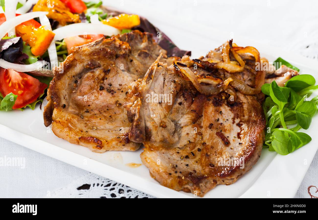 roasted-pork-steak-with-vegetable-salad-stock-photo-alamy