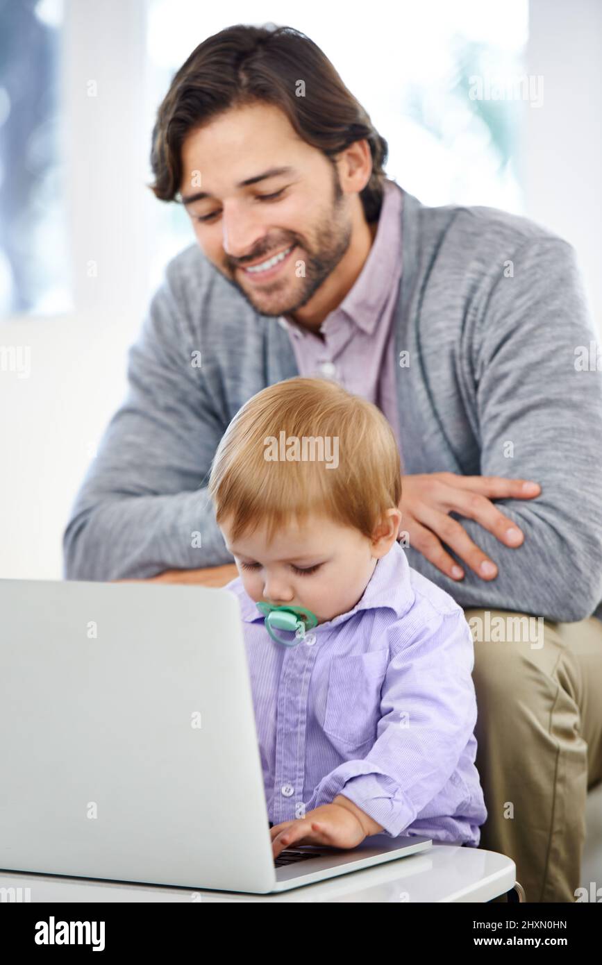 Hes going to follow after his dad. A handsome young man with his baby boy. Stock Photo