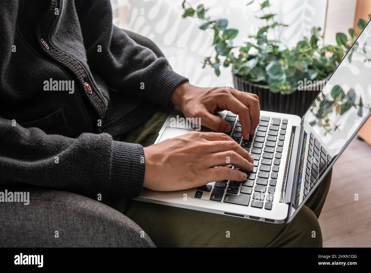 Man working from home, using laptop Stock Photo