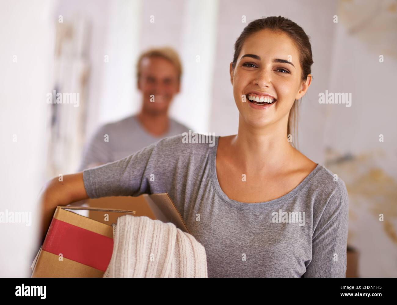 Moving onwards and upwards. Portrait of a young woman holding a box on moving day. Stock Photo
