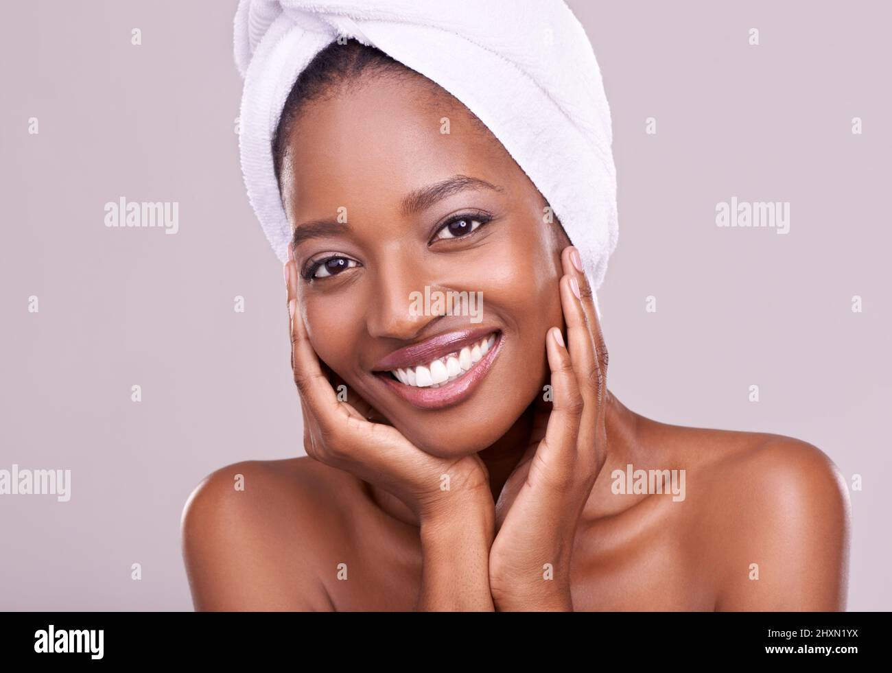 To be beautiful is to be yourself. An isolated studio portrait of a beautiful young woman wearing a towel on her head. Stock Photo