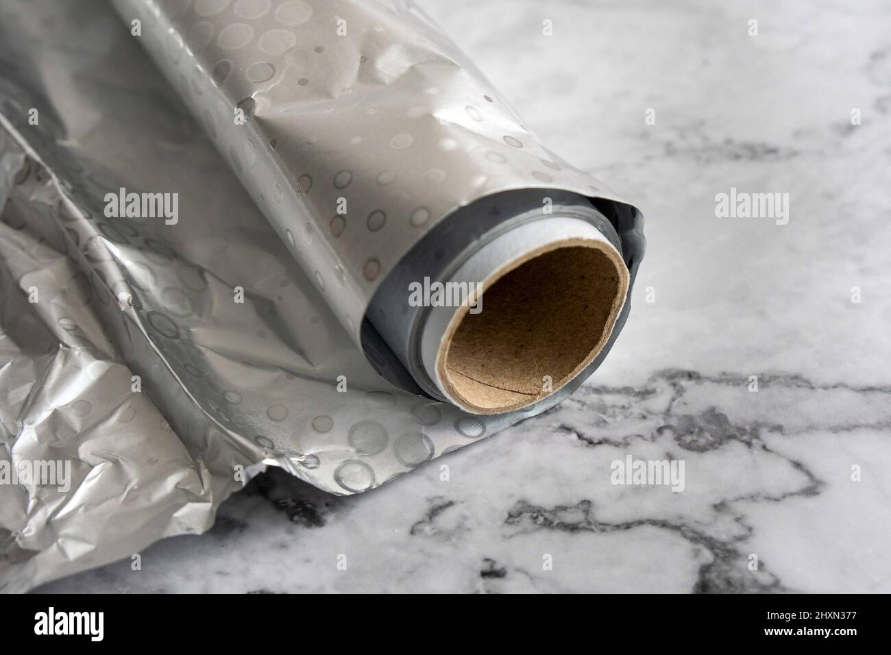 A roll of aluminium foil, a material often used in the kitchen. Stock Photo