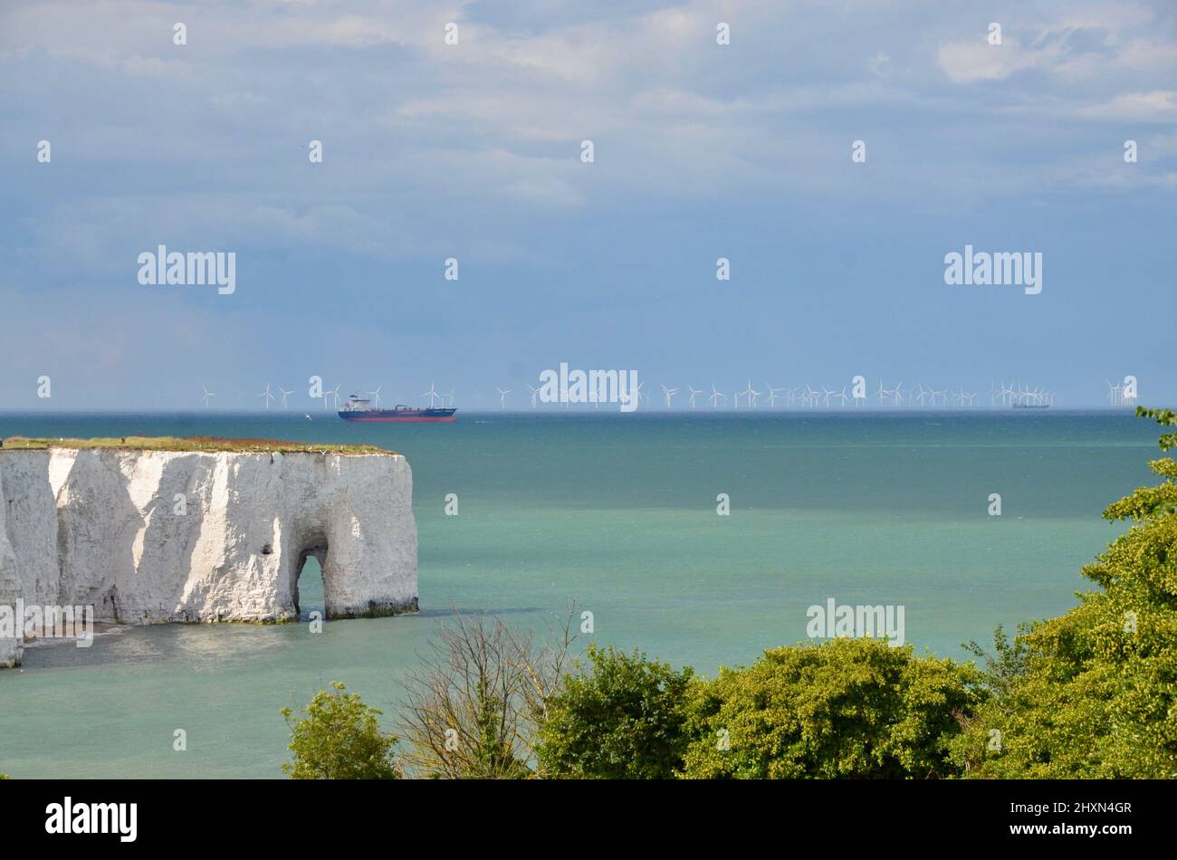 Wind farms and boat on the horizon. Botany Bay, Kent, England. Warm day