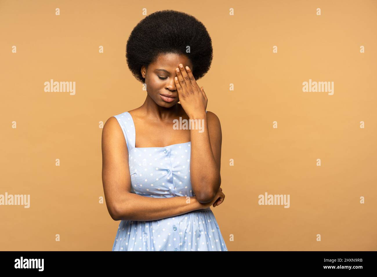 Shocked black female cover face with hand after bad news crying received bad e-mail feels unhappy Stock Photo