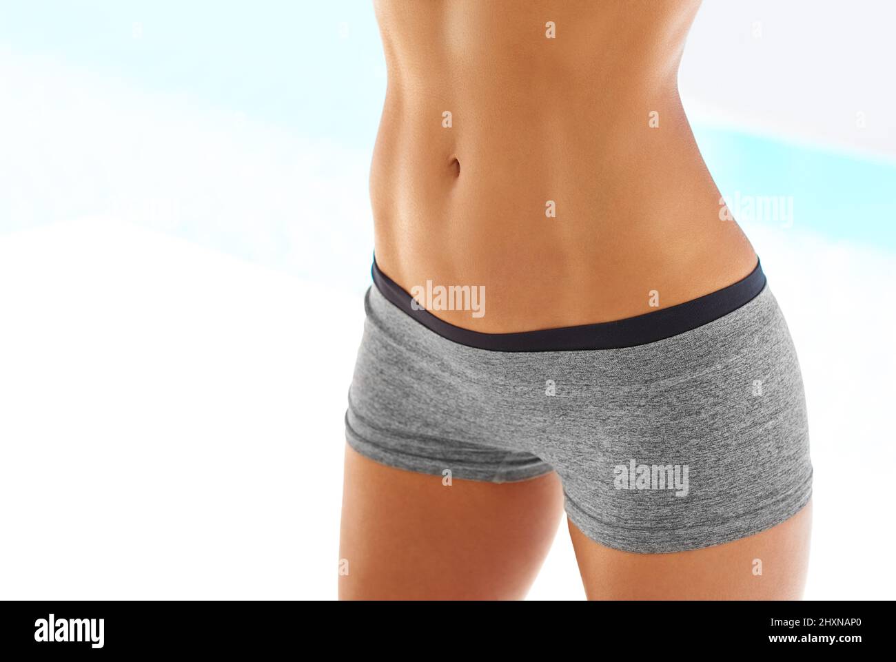 Premium Photo  A young slender woman with toned stomach with abs result of  fitness diet healthy lifestyle