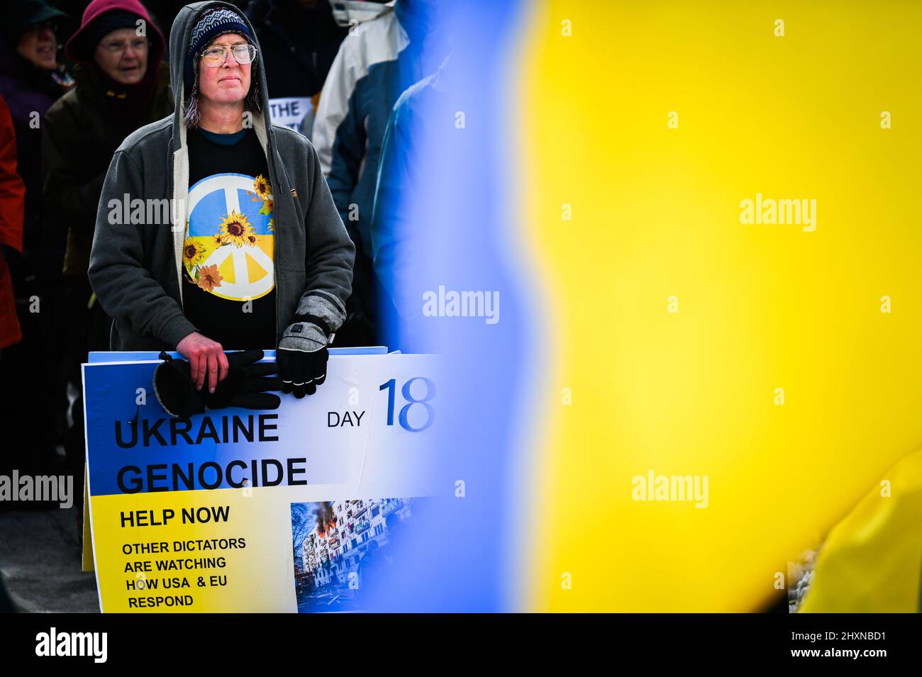 A pro-Ukraine demonstrator stands at a Vermont Stands with Ukraine rally at the Vermont State House, Vermont, New England, USA, March 13, 2022. Stock Photo