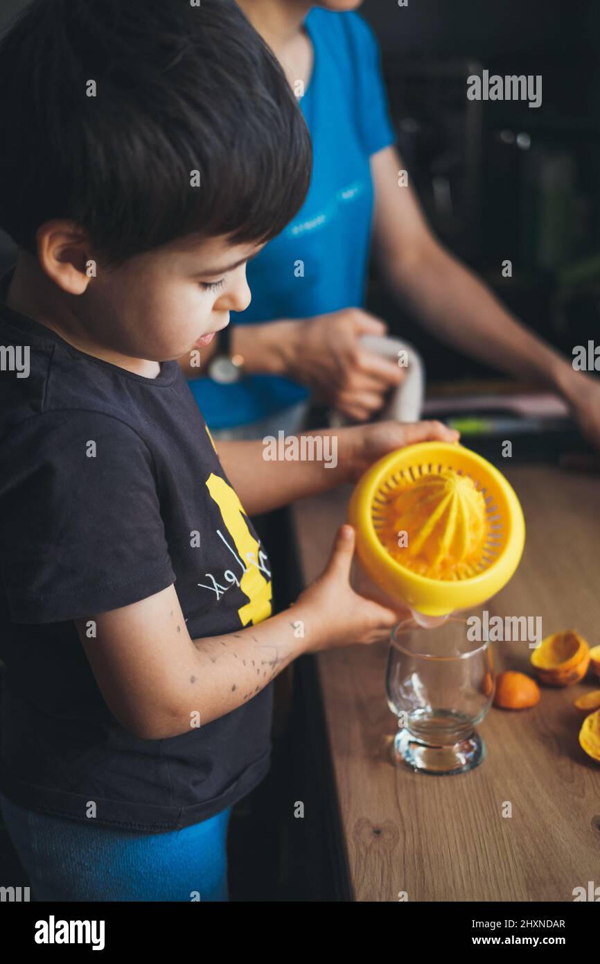 toddler drinking orange juice from gripper bottle Stock Photo - Alamy