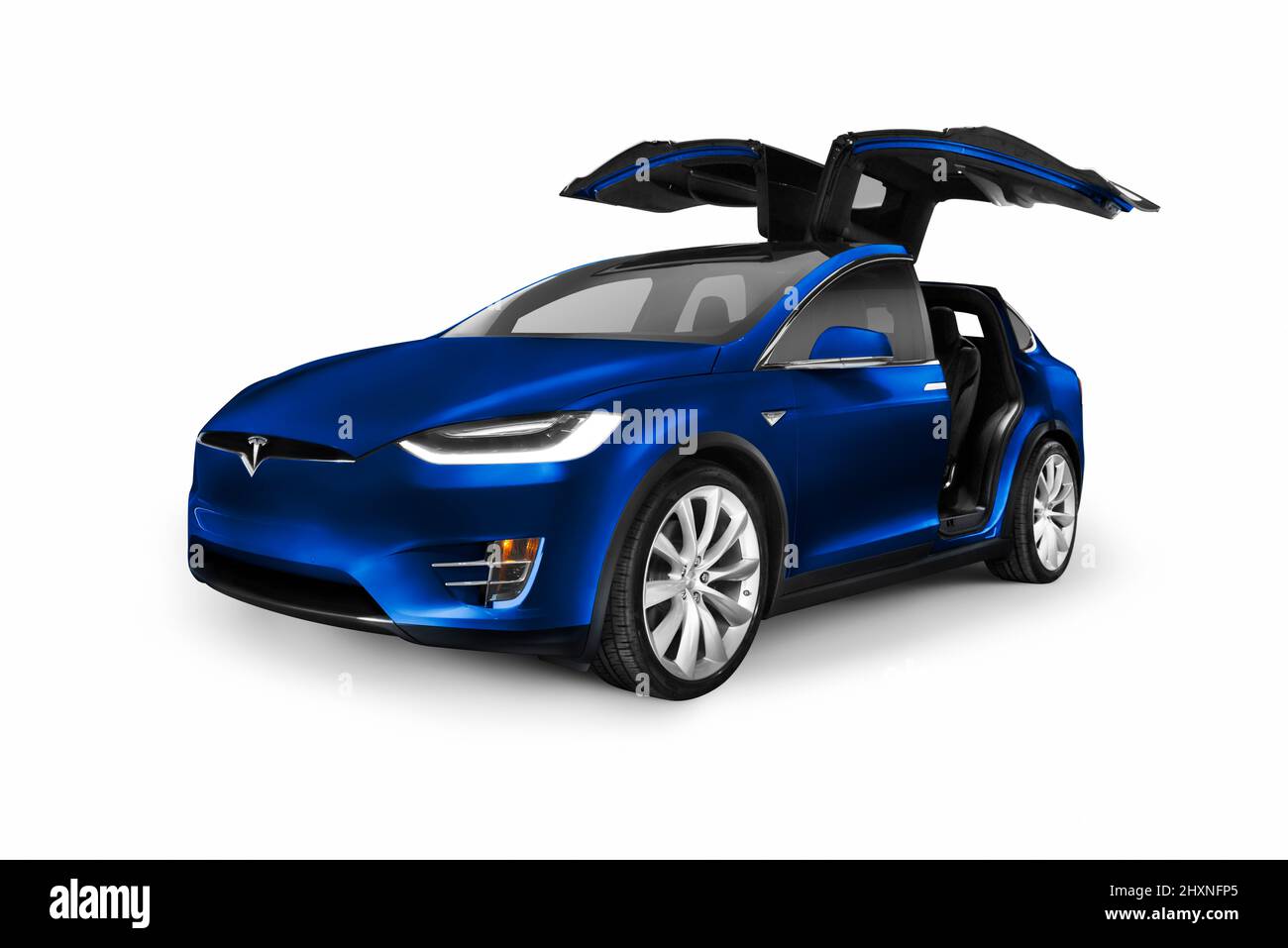 Tesla Model X, Deep Blue Metallic, luxury SUV electric car with open falcon wing doors isolated on white background Stock Photo
